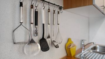 A kitchen with a utensil rack holding various kitchen tools.