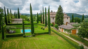A well-manicured garden with a swimming pool, tall cypress trees, and stone buildings with terracotta roofs. - Il Poggio Alle Trese 14 Emma Villas (Citta della Pieve)