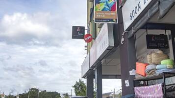 A storefront with a sign for 'soon ee hardware' and a 'seamaster paint' advertisement.