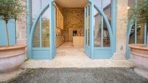 A modern building with a stone facade and a large arched entrance. - La Glycine (Tonnac)