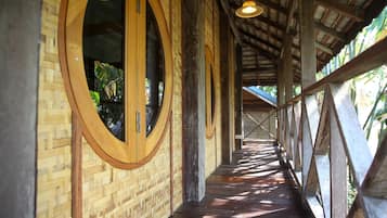 Walkway with large windows, wooden beams, and a low wall for a secure and airy feel.