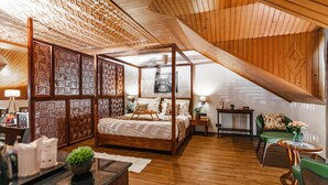 A spacious bedroom with a four-poster bed, wooden ceiling, and a view of the outdoors. - The Sarai (Srinagar)