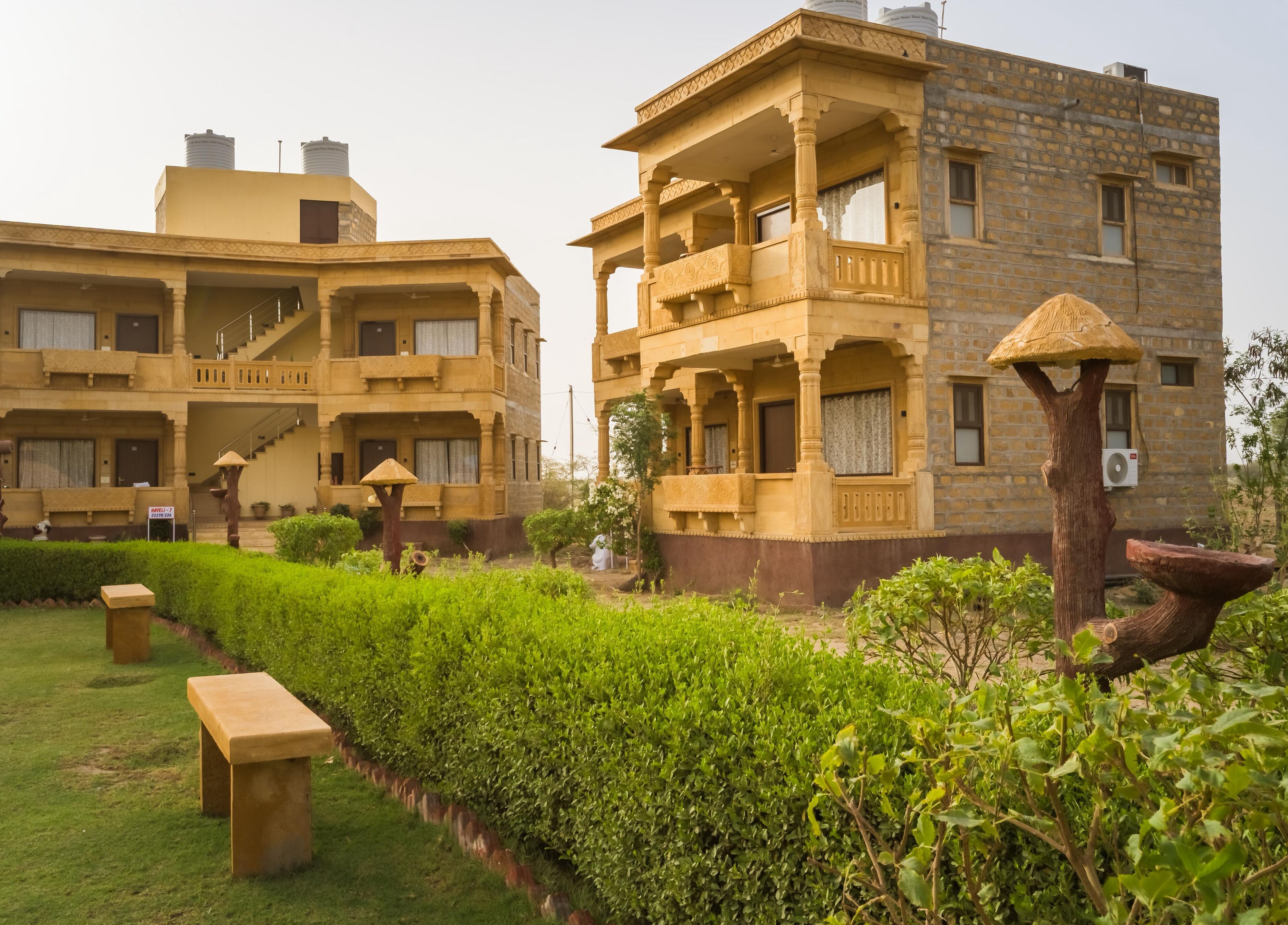 A traditional building with multiple balconies and a well-maintained garden.