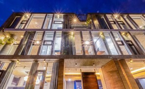 A modern multi-story building with large windows and a wooden entrance. - 135 B&B (Dongshan)