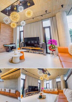 A modern living room with a large TV, comfortable seating, and decorative lighting. - 135 B&B (Dongshan)