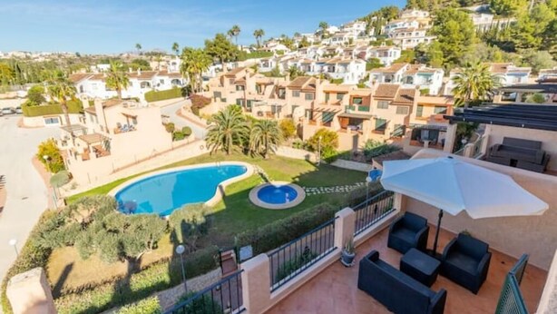 A residential area with a swimming pool, patio furniture, and a view of the neighborhood. - Dimora Floriana by Sun & Sea (Moraira)