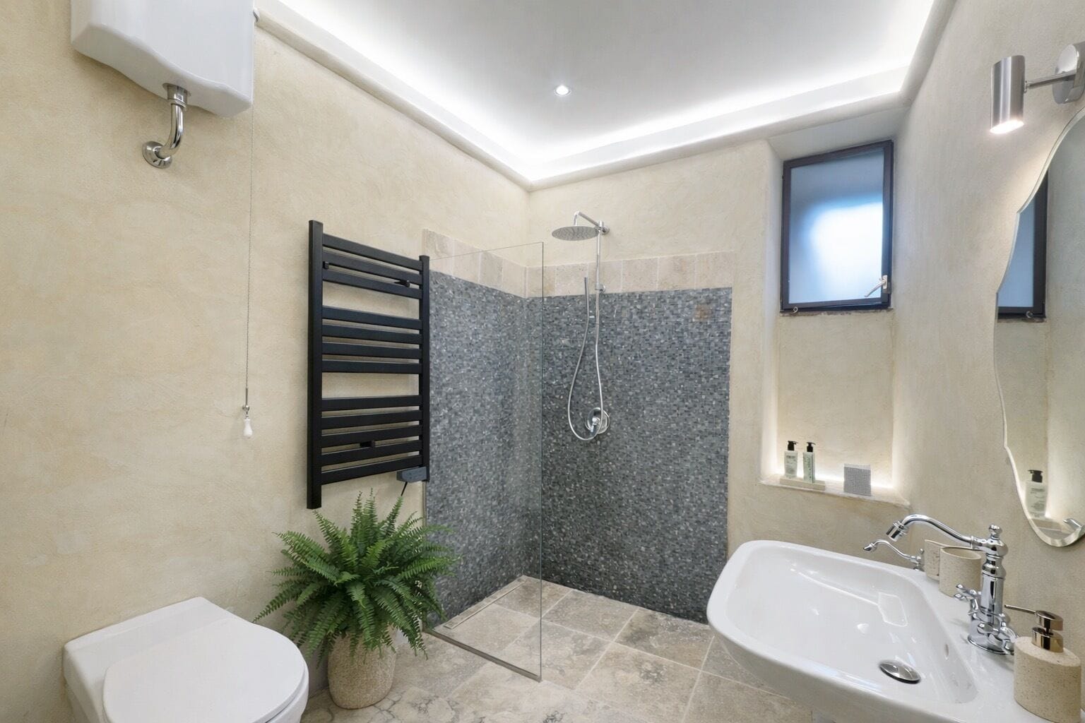 A modern bathroom with a shower, toilet, and bathtub.