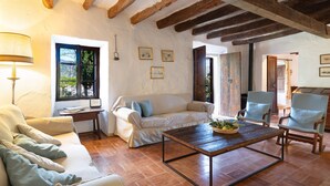 A living room with a sofa, armchairs, a coffee table, and a lamp. - Finca Es Coste by Rentallorca (Pollensa)
