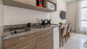 A modern kitchen with granite countertops, a built-in sink, and wooden cabinets.