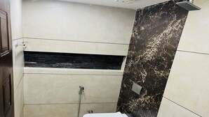 A bathroom with a shower, toilet, and a sink. - The Tendo Inn (Pollachi)