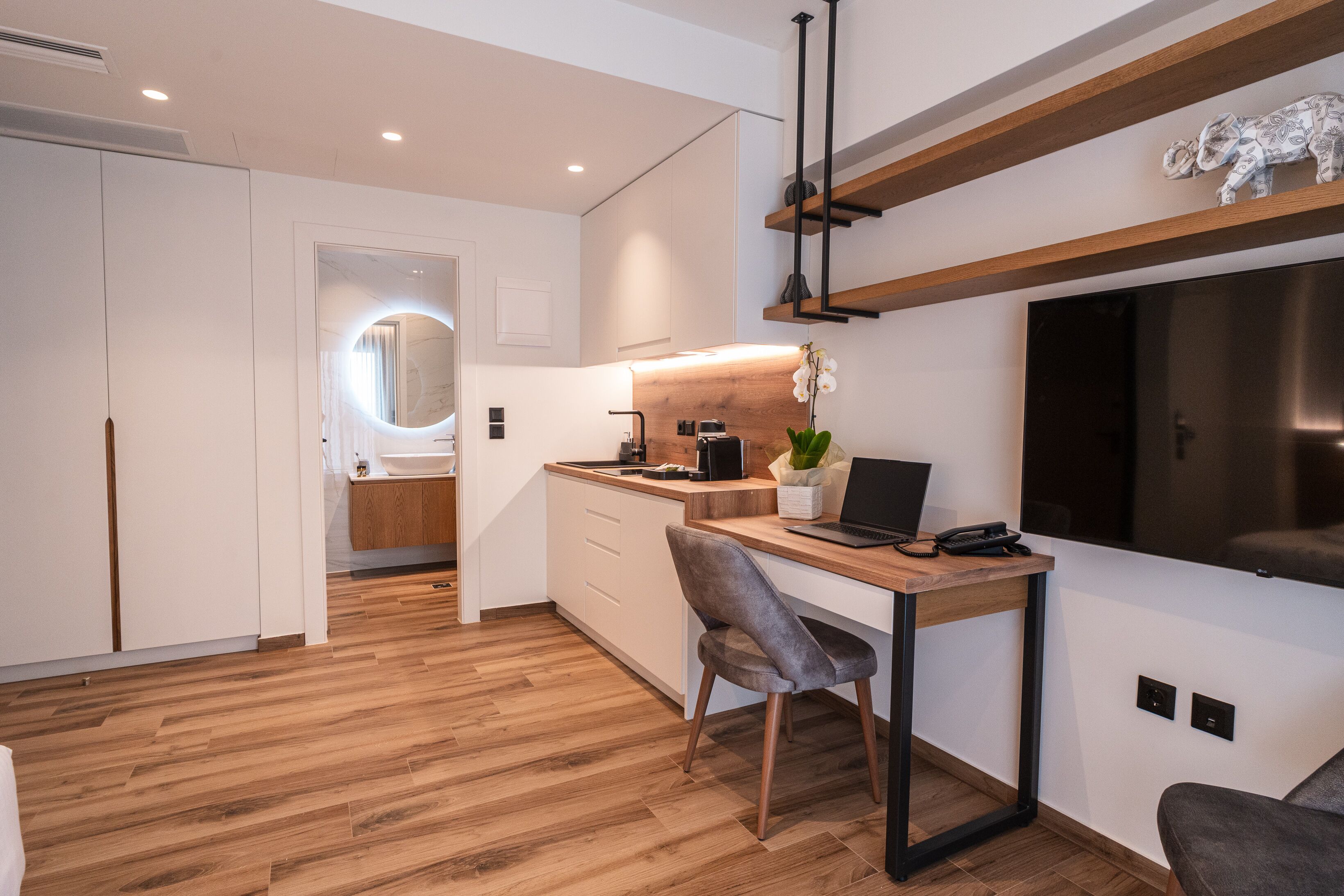 A modern kitchen with a wooden countertop, a built-in oven, and a sink.