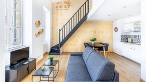 A modern living space with a staircase, a sofa, a dining area, and a kitchen. - Beautiful apartment with Parking at Bordeaux (Bordeaux)