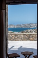 A stone wall with a view of a coastal town and the sea.