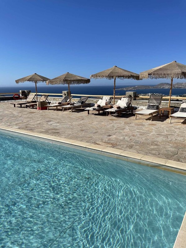 Seasonal outdoor pool, pool umbrellas, pool loungers