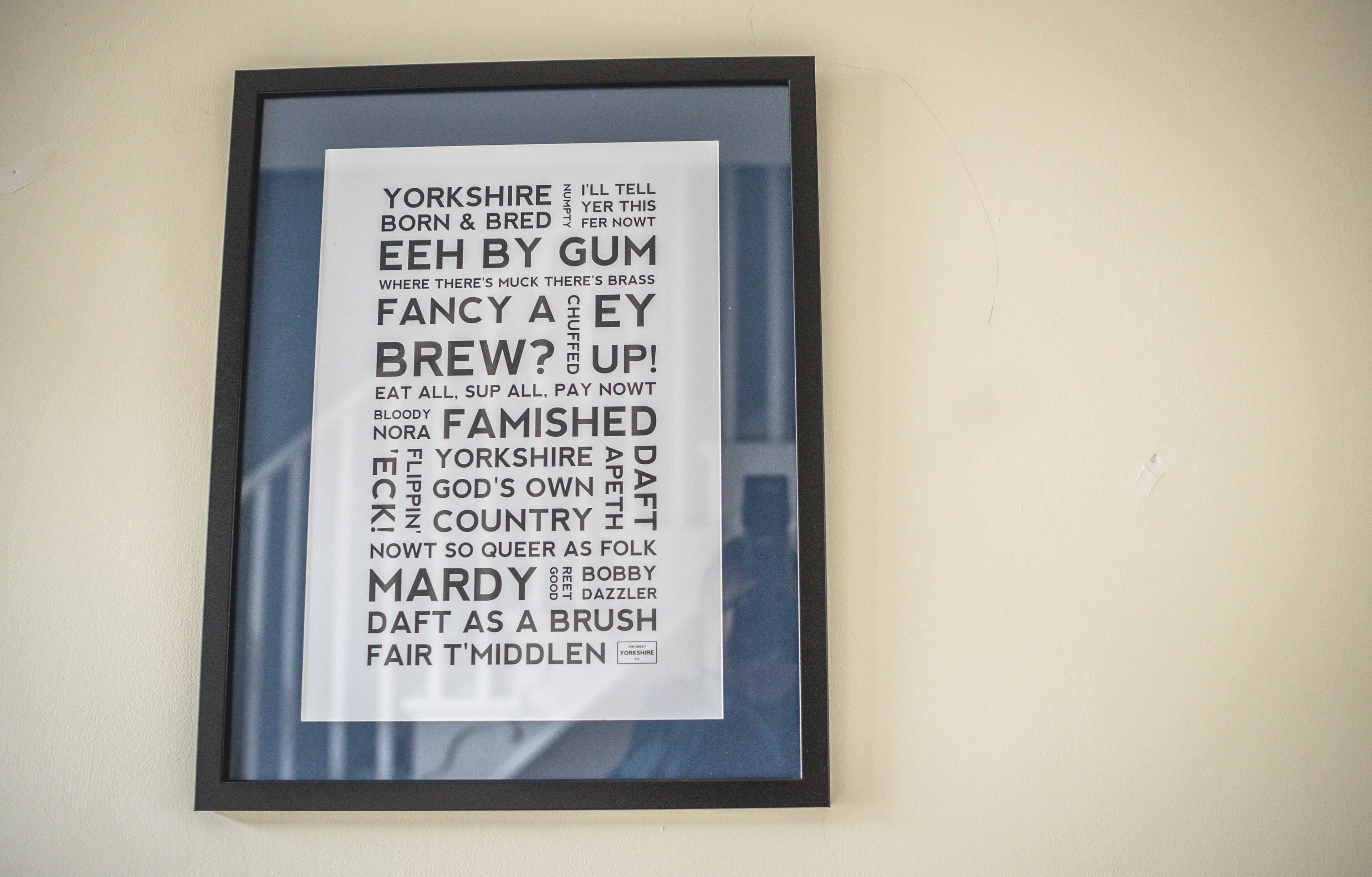 A framed text poster with a list of words and phrases.