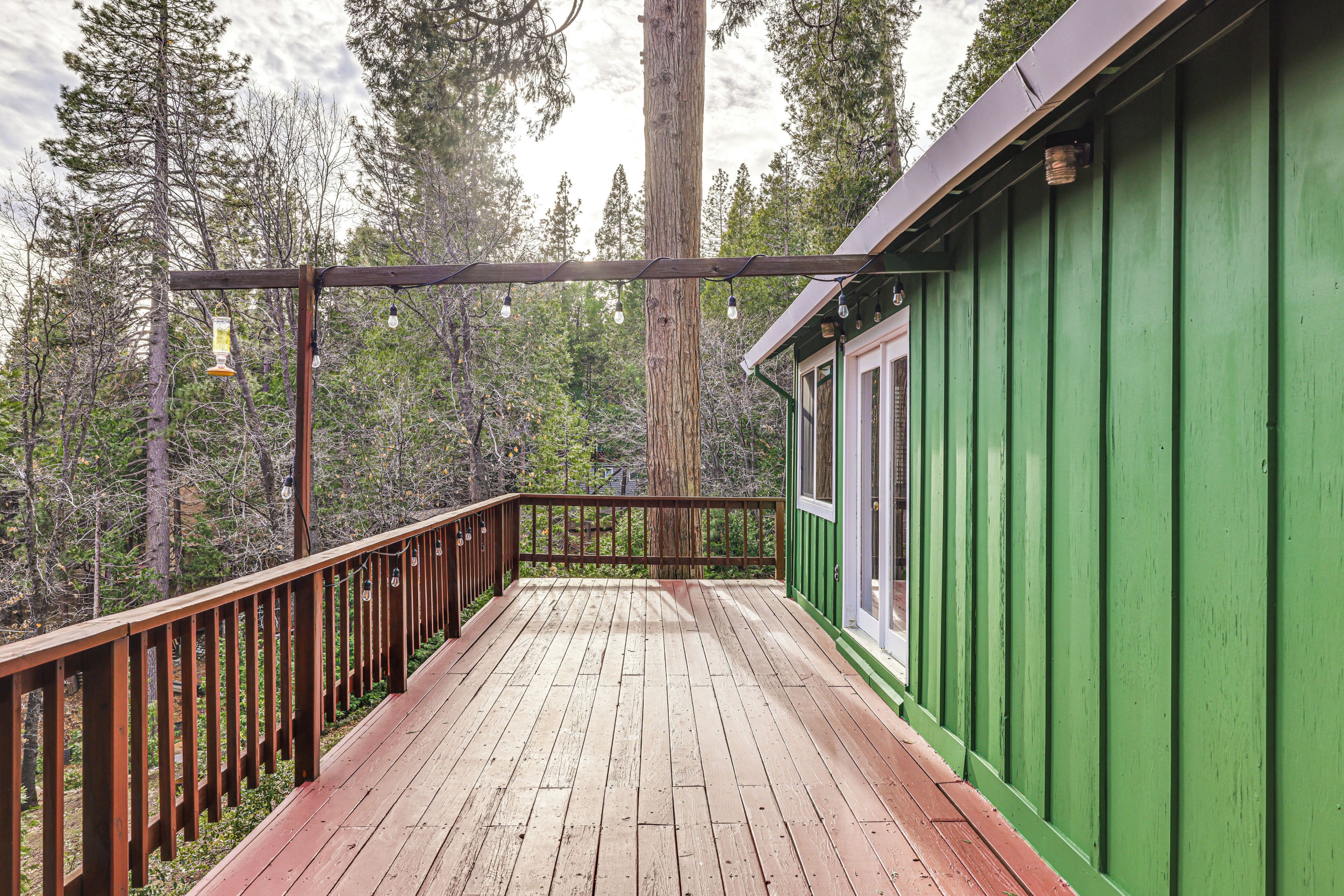 A wooden deck with a green building in the background.