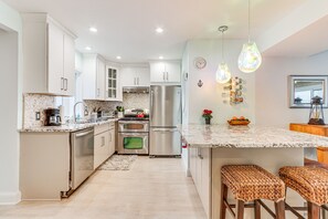 Enjoy cooking in this well-lit kitchen with a central island and stainless steel appliances.