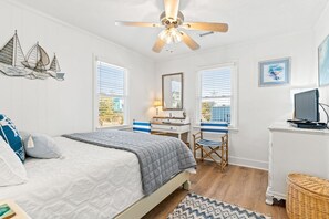 A bedroom with a bed, desk, chair, and a ceiling fan. - Dunebug Cottage / 319 Sandpiper Lane 3 Bedroom Home by RedAwning (Supply)