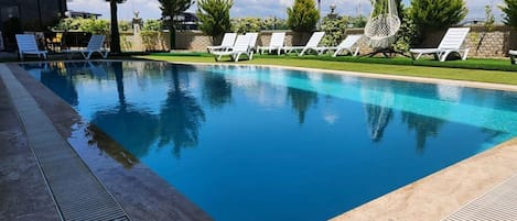 Seasonal outdoor pool, open 9:00 AM to 9:00 PM, pool umbrellas