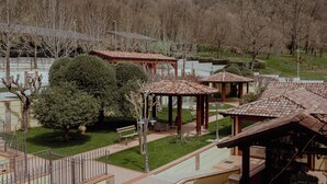 A gazebo with a tiled roof, surrounded by a well-maintained lawn and trees. - San Raffaele Hotel Restaurant & Resort (Castelluccio Superiore)