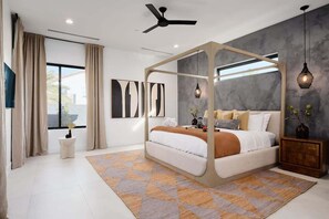 A modern bedroom with a canopy bed, a ceiling fan, and a large window. - Tulum House - Pool Heat Available - Fire Pit (Scottsdale)