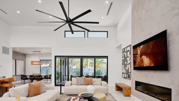 A modern living room with a sofa, coffee table, and TV.