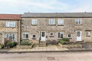 A stone-built terraced house with multiple windows, a front door, and a small garden area. - Between Coast & Moors • Pickering 2BR • Sleeps 4 (Pickering)