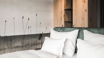 A modern bedroom with a large bed, wooden headboard, and a textured wall.