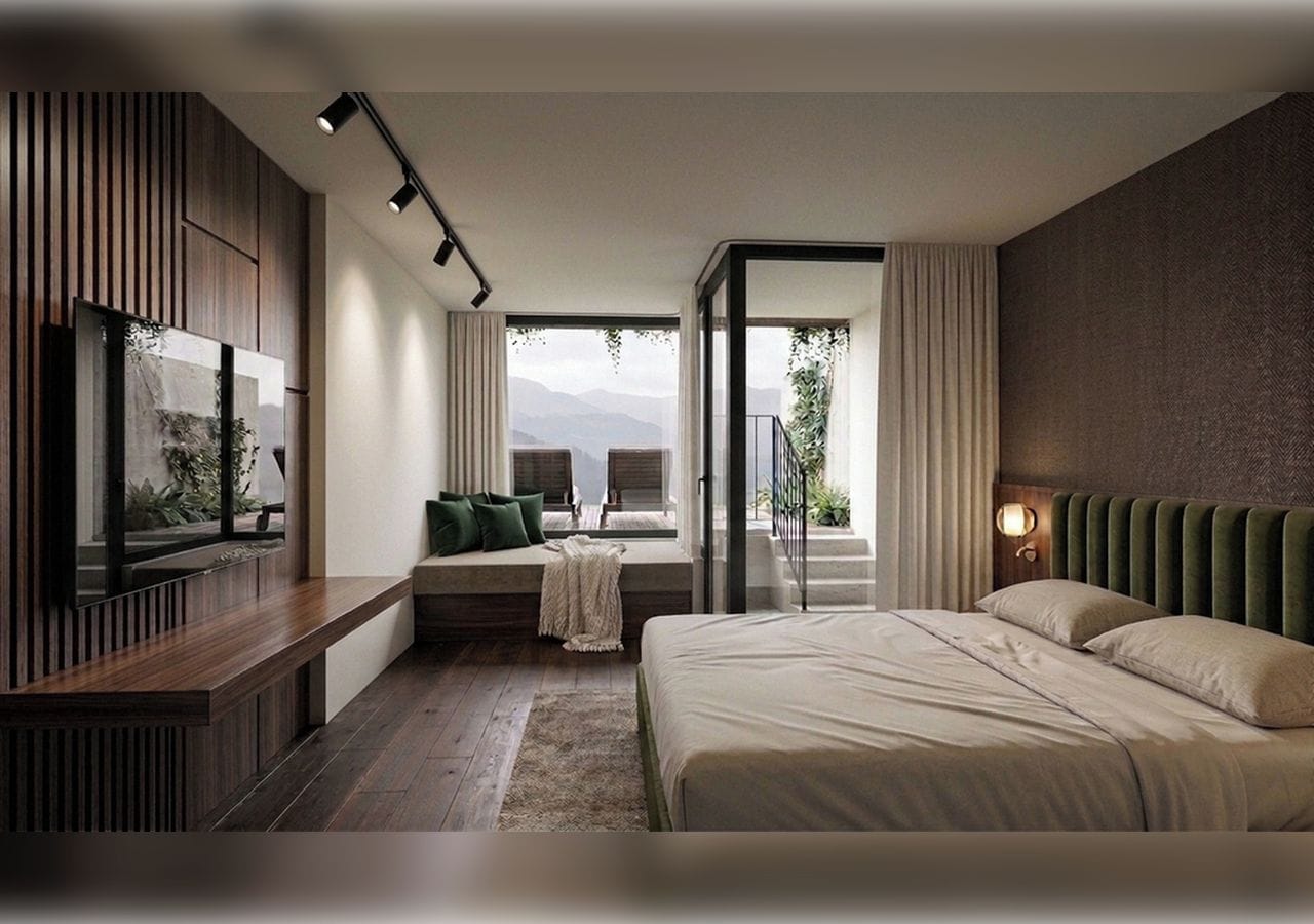 A modern hotel room with a large bed, a seating area with a view, and a television on the left wall.