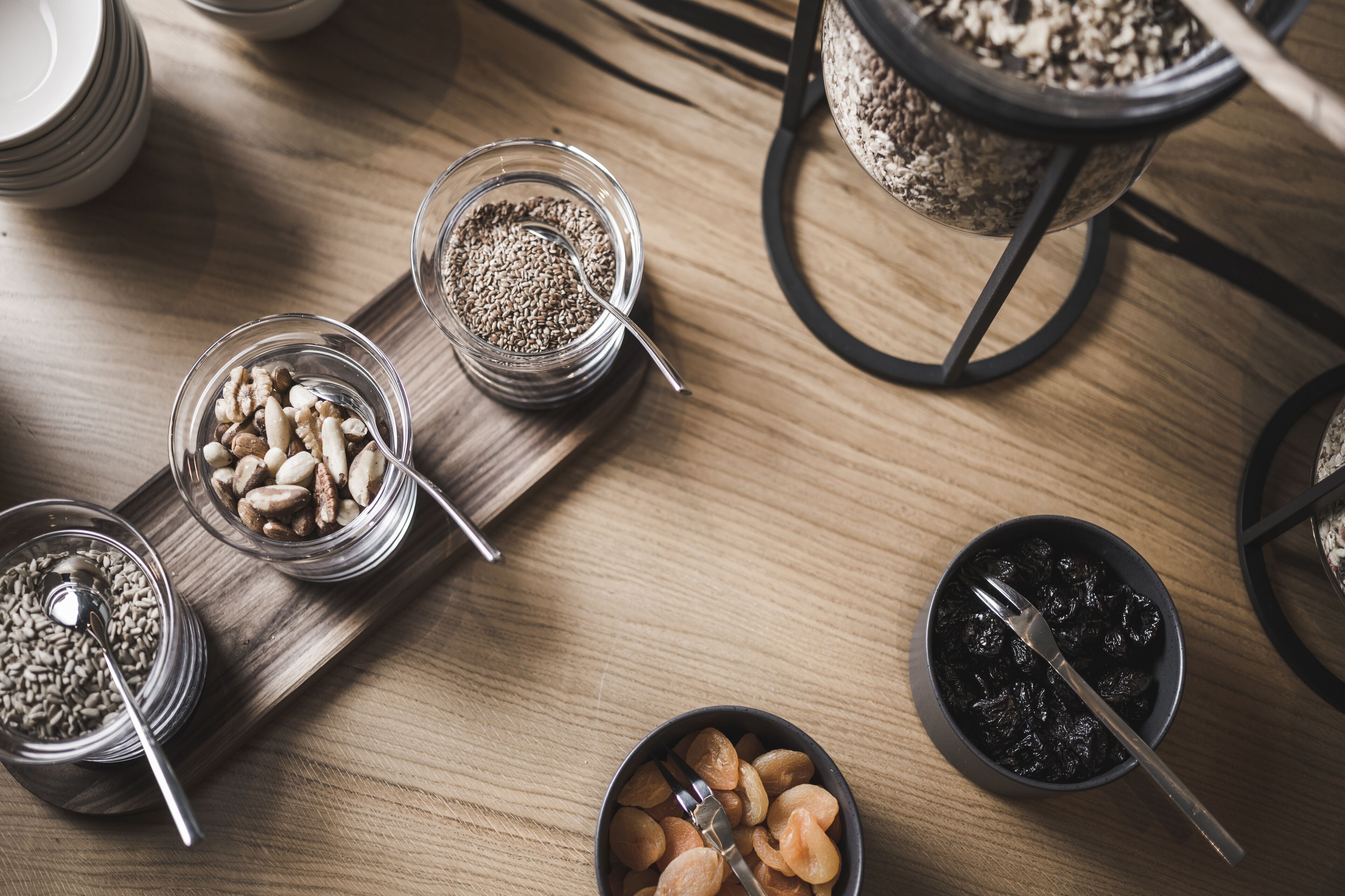 A wooden table with various food items and utensils.