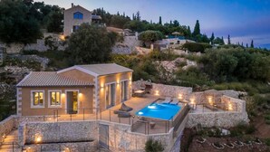 A stone villa with a swimming pool, outdoor seating, and a stone staircase. - Villa Eugenia Sunrise (Kefalonia)
