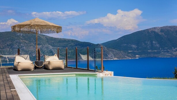 An infinity pool with a view of a mountain and a body of water. - Villa Bolios Sea View Private Pool (Kefalonia)