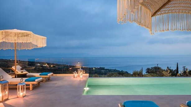 A rooftop pool area with lounge chairs, umbrellas, and a view of the sea. - Casa Grec Villa Kefalonia (Kefalonia)