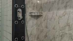 A shower with a handheld showerhead and a wall-mounted control panel. - Magganos House Kefalonia (Kefalonia)
