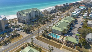 A coastal hotel with a pool, beachfront view, and multiple buildings. - Caribbean Dunes by Panhandle Getaways (Destin)