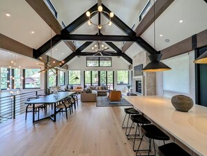 A spacious kitchen with a long counter, dining area, and seating. - Luxury Home • Pvt Hot Tub • Pool • Shuttle (Keystone)