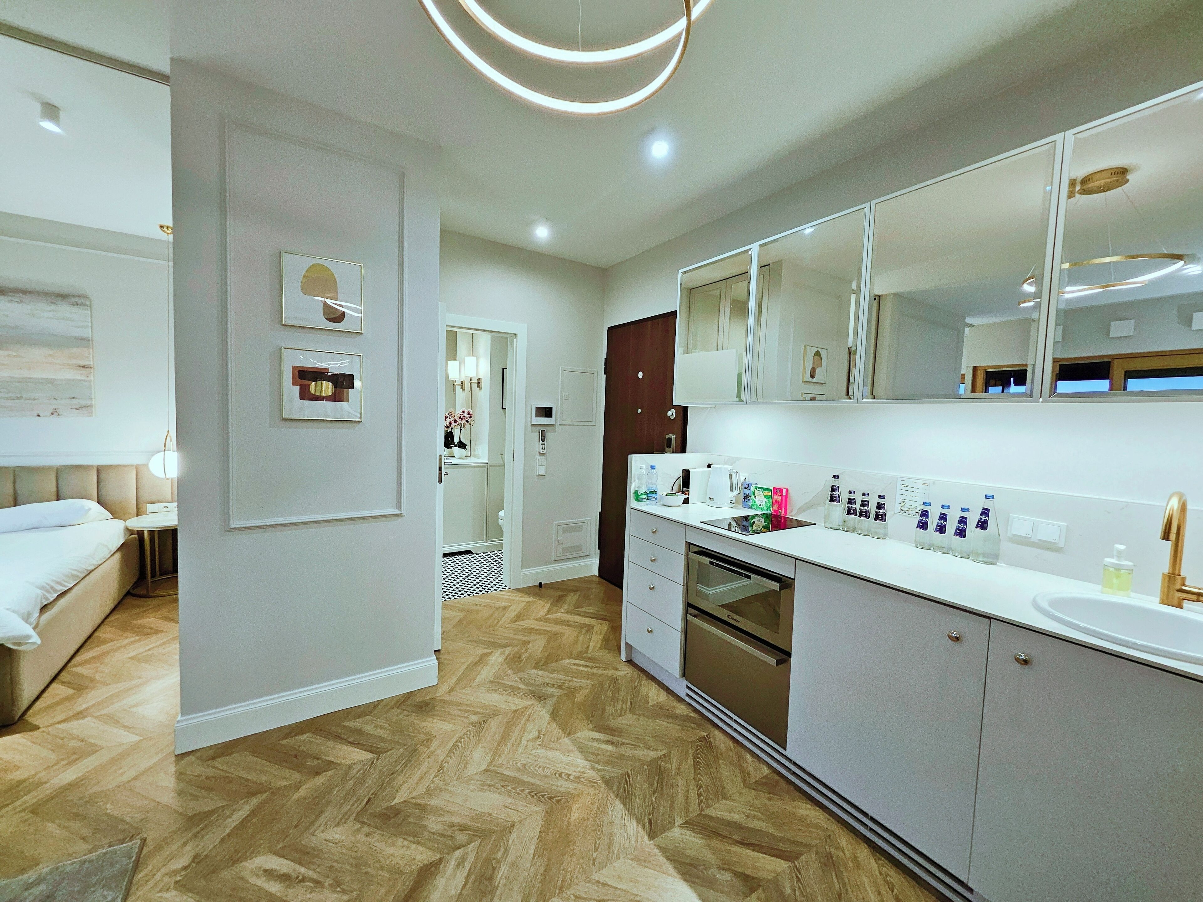 A modern kitchen with a built-in oven, a microwave, and a coffee maker.