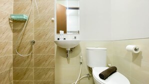A bathroom with a shower, sink, toilet, and a mirror. - Minimalist Studio Apartment At Transpark Juanda Bekasi Timur (Bekasi)