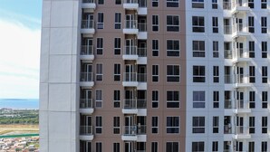 A high-rise building with multiple balconies and windows. - Minimalist And Restful Studio Tokyo Riverside Pik 2 Apartment (Teluknaga)