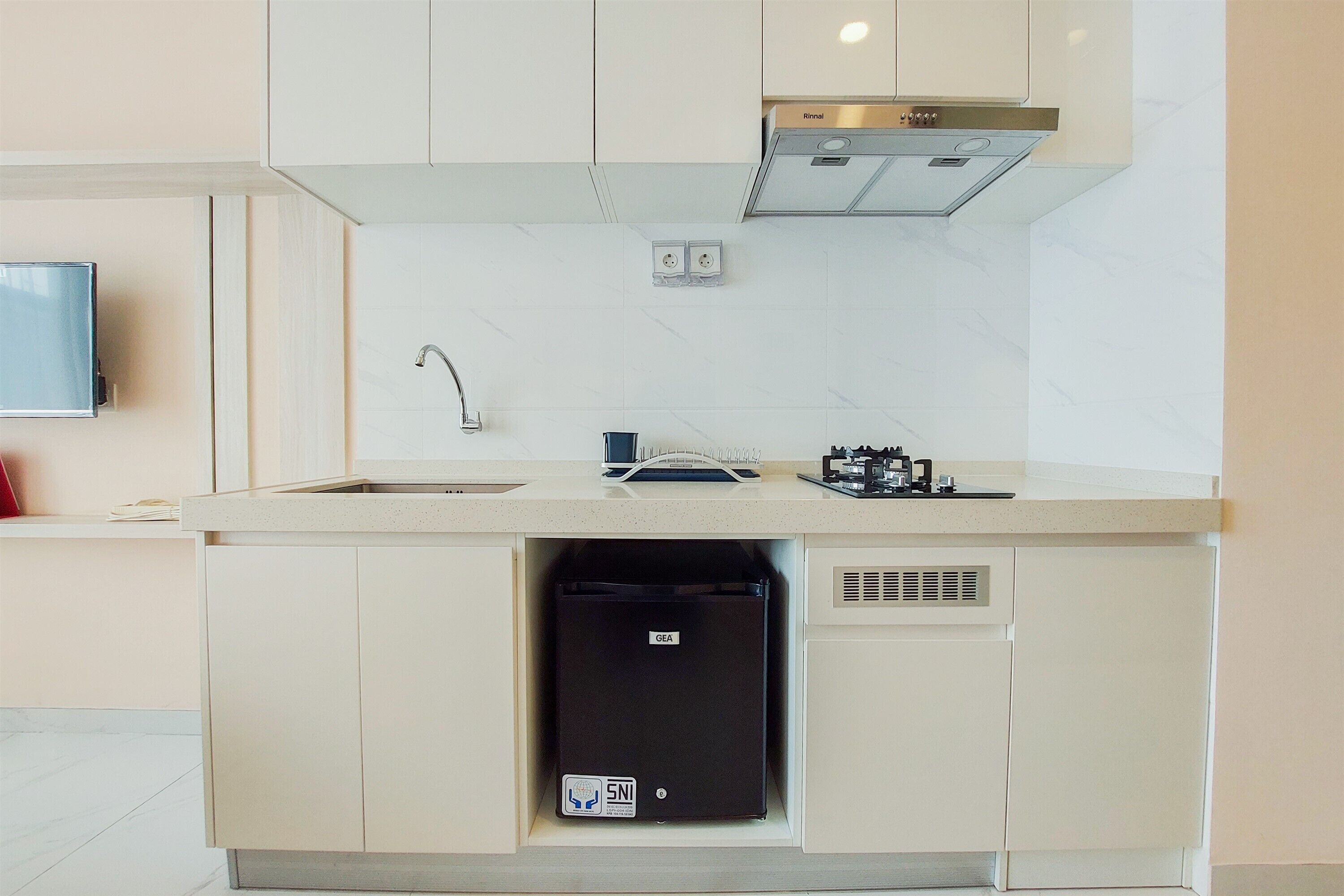 A modern kitchen with a built-in dishwasher, a sink, and a stove.