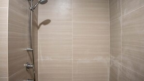 A shower with a handheld showerhead and a wall-mounted control. - Well Appointed And Homey Studio At West Vista Apartment (Jakarta)