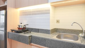 A kitchen with granite countertops, a stainless steel sink, and a built-in oven.