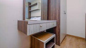 A bathroom with a wooden vanity, a mirror, and a shelf. - Comfortable And Warm 2Br At Tifolia Apartment (Jakarta)