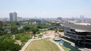 A modern building with a curved roof and a swimming pool.