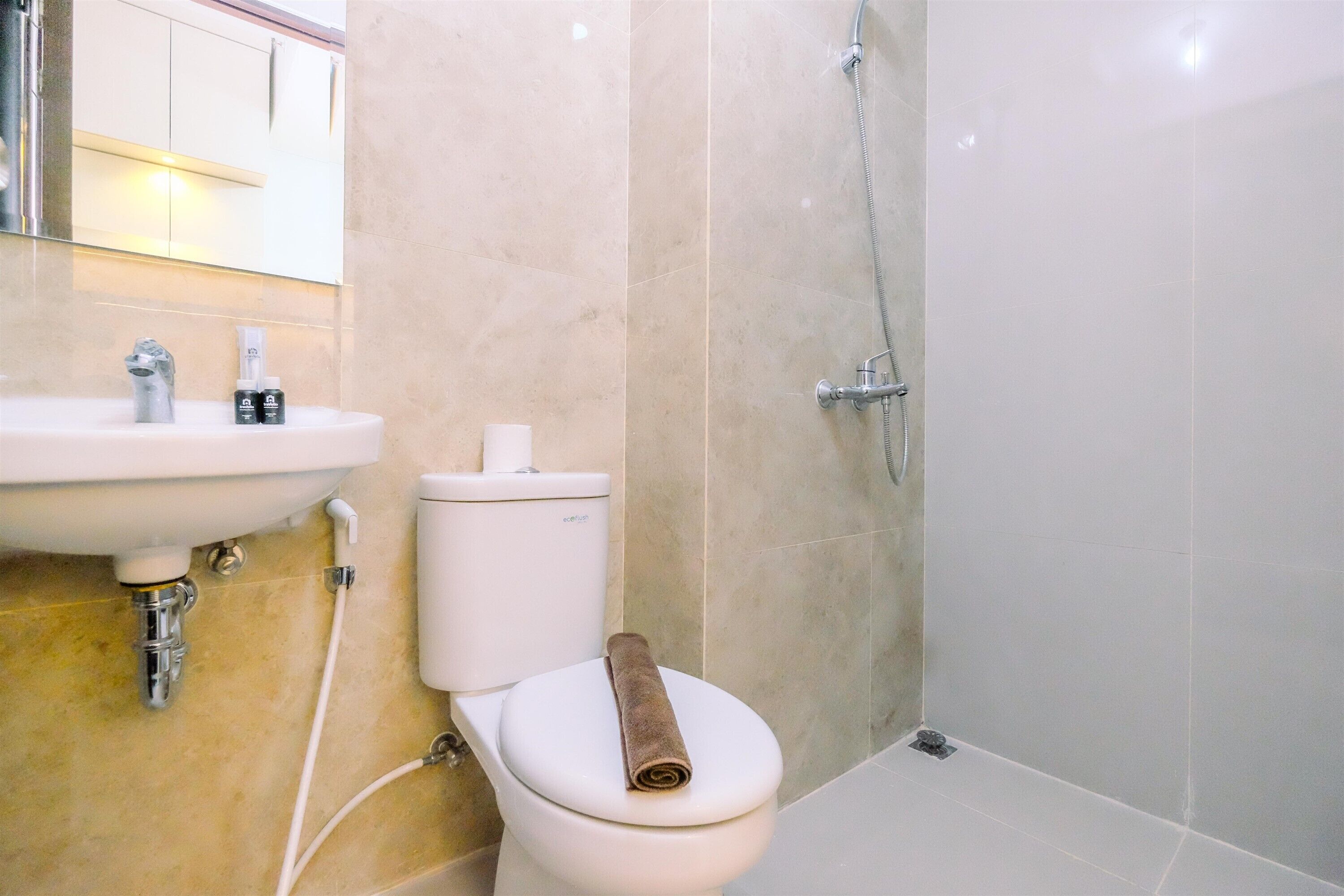 A bathroom with a sink, toilet, and shower.