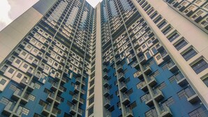 A high-rise residential building with multiple balconies and a modern architectural design. - Modern Look And Comfortable Studio Evenciio Margonda Apartment (Depok)