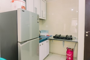 Apartment | Private kitchen | Fridge, stovetop, rice cooker, dining tables - Modern Look And Homey 2Br At Great Western Resort Apartment (Tangerang)