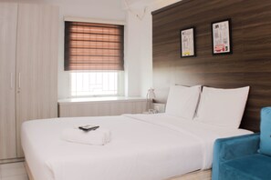 Relax in a cozy space with a comfortable bed, a bedside table, and a chair.