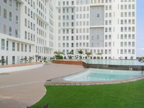 Guests can enjoy a refreshing swim in the hotel's pool surrounded by lush greenery.