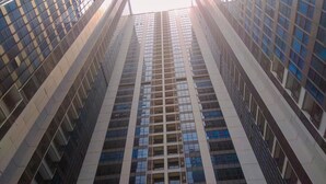 A high-rise building with a modern architectural design, featuring a grid of windows and balconies. - Comfortable 2Br At Apartment Casa Grande Residence (Jakarta)